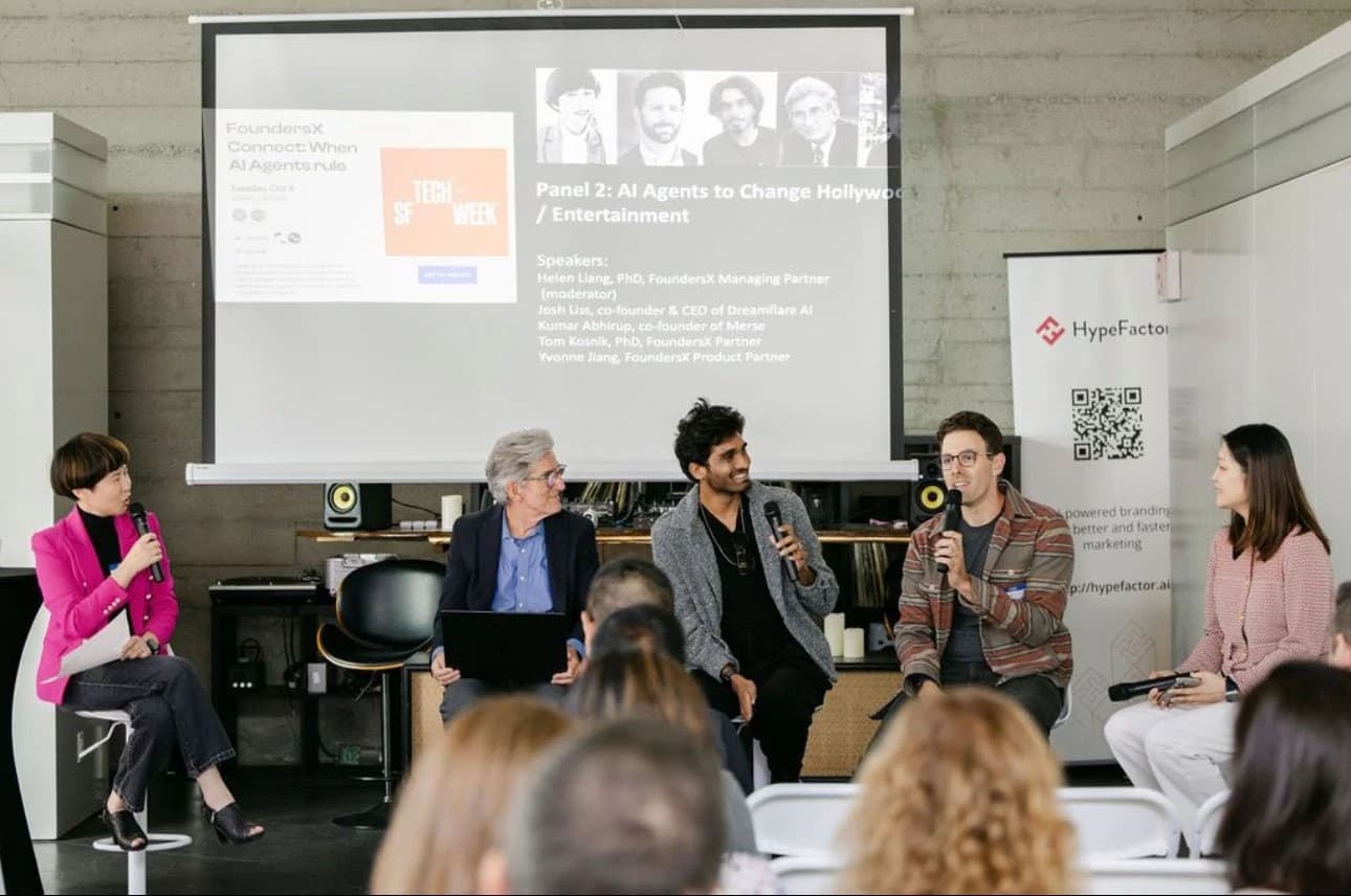 Speaking into a microphone during a panel discussion.