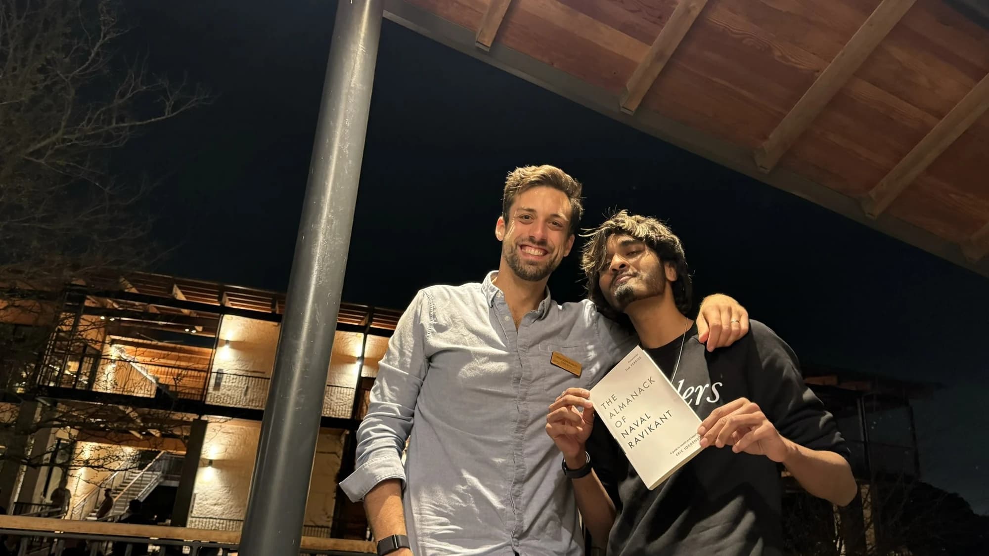 With Eric Jorgenson, holding a copy of The Almanack of Naval Ravikant.