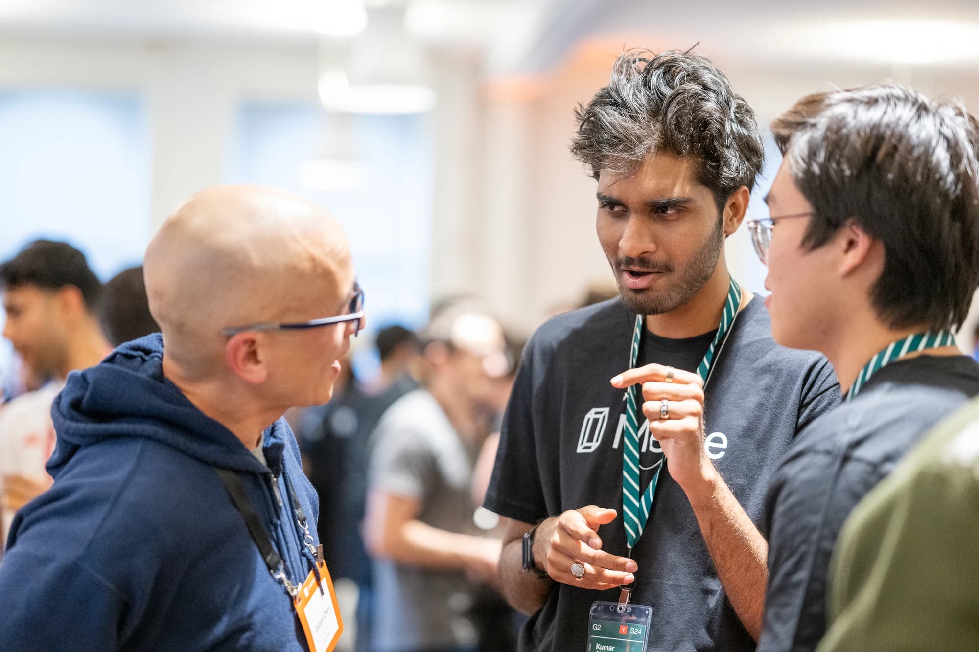 Three people in conversation at an event.
